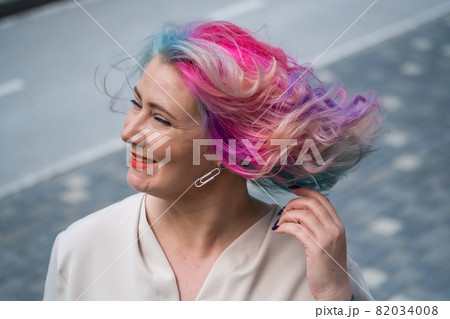Close-up portrait of curly Caucasian woman with multi-colored hair. Model for hairstyles 82034008