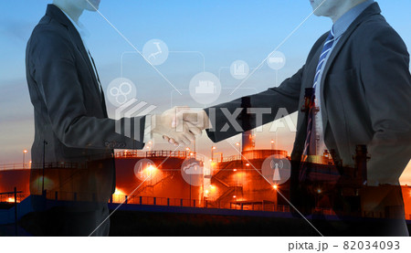 Two petrochemical contractors closing a deal in front of an oil refinary,Future factory plant and energy industry Oil, gas and petrochemical refinery factory Two petrochemical contractors closing a deal in front of an oil refinary,Future factory plant and energy industry Oil, gas and petrochemical refinery factory 82034093