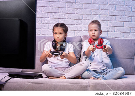 children playing video game with game console 82034987