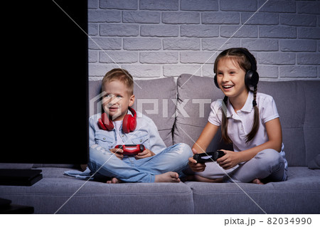 children playing video game with game console children playing video game with game console 82034990