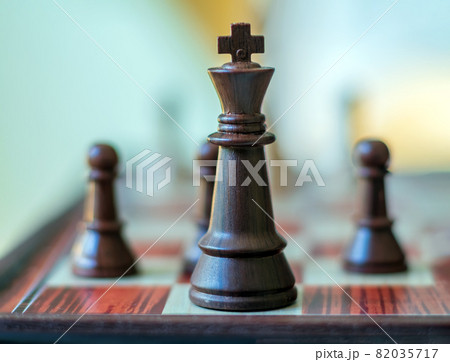 Chess pieces are standing on the board. Black chess king. Close-up. Chess pieces are standing on the board. Black chess king. Close-up. 82035717