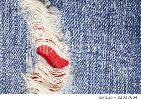 Torn denim jeans texture. Torn denim jeans texture. 82037604