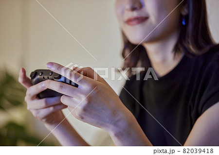 リビングでゲームをする若い日本人女性 82039418