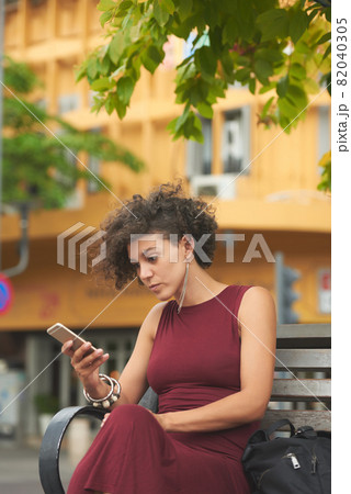 Serious Woman Reading Text Messages 82040305