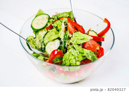 Vegetable salad with olive oil on a white background Vegetable salad with olive oil on a white background 82040327