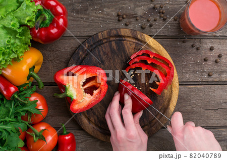 Female hands cutting pepper at table, top view 82040789