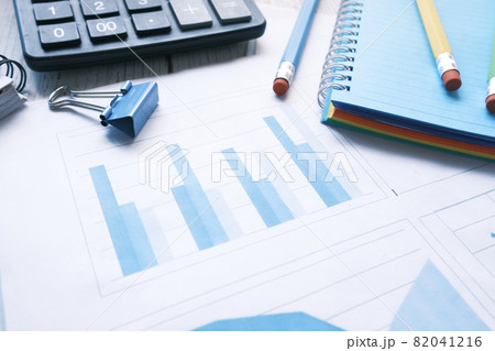 financial graph, calculator and notepad on table financial graph, calculator and notepad on table 82041216