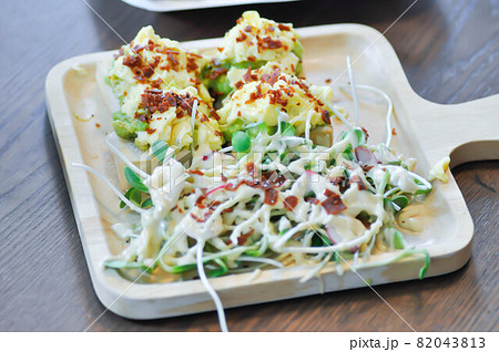 salad and avocado toast ,sunflower sprout salad with bacon topping and canape 82043813