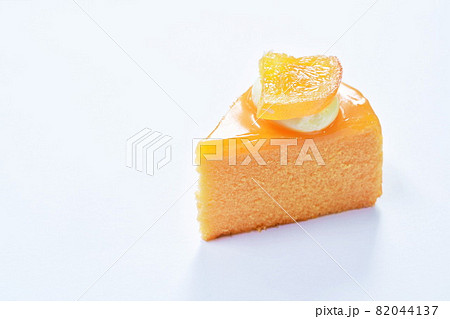orange cake with cream topping fruit on white background 82044137