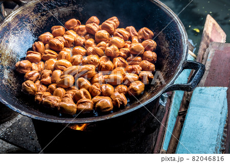 Frying meatballs in old frying pan on firewood stoves Frying meatballs in old frying pan on firewood stoves 82046816
