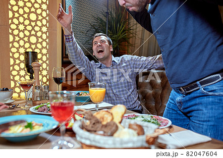 two men in a restaurant arguing during lunch two men in a restaurant arguing during lunch 82047604