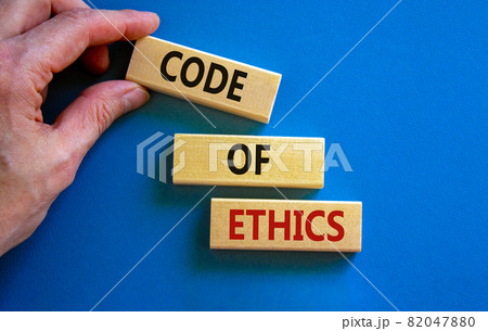 Code of ethics symbol. Concept words 'Code of ethics' on wooden blocks on a beautiful blue background. Businessman hand. Business and code of ethics concept. Copy space. Code of ethics symbol. Concept words 'Code of ethics' on wooden blocks on a beautiful blue background. Businessman hand. Business and code of ethics concept. Copy space. 82047880