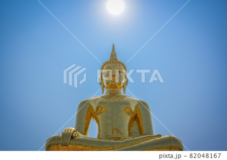 Golden buddha witn peaceful face under the sun at noon , calm and mindfulness concept 82048167