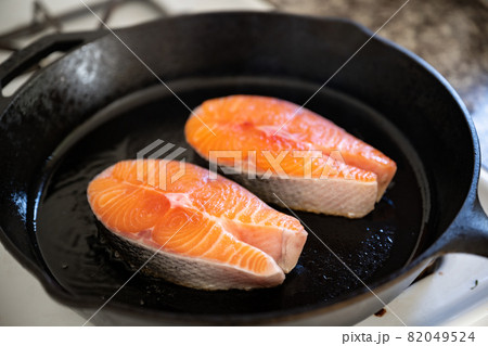 grilling salmon fillet steak on iron skillet pan grilling salmon fillet steak on iron skillet pan 82049524