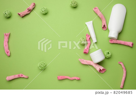 empty white plastic tubes, jar for cosmetics on a green background. Packaging for cream, gel, serum, advertising and product promotion, top view empty white plastic tubes, jar for cosmetics on a green background. Packaging for cream, gel, serum, advertising and product promotion, top view 82049685