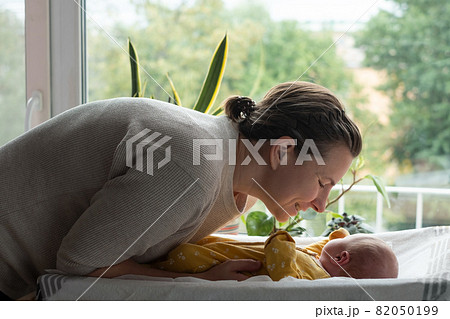 Caucasian mother changing baby girl clean cloth Caucasian mother changing baby girl clean cloth 82050199