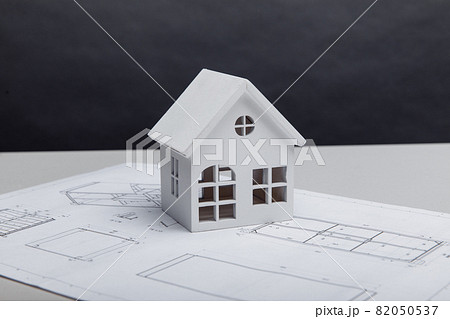 Model of house on drawing. Building and architect concept 82050537