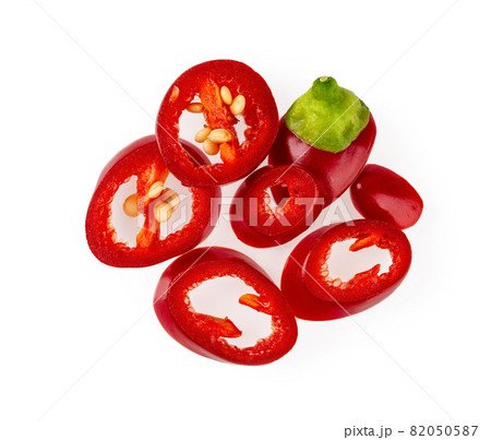 Heap of raw red hot chili pepper slices isolated on a white background. Heap of raw red hot chili pepper slices isolated on a white background. 82050587
