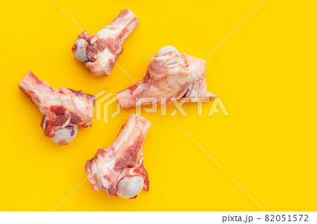 Raw pork bones on yellow background. Raw pork bones on yellow background. 82051572
