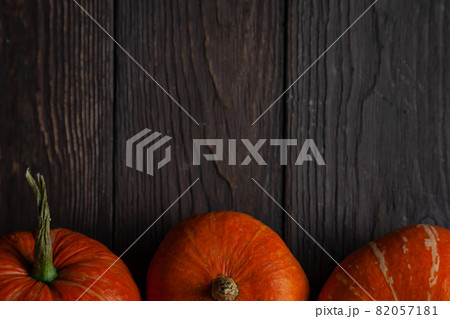 Three pumpkins in a row on wooden table. Copy space. Three pumpkins in a row on wooden table. Copy space. 82057181