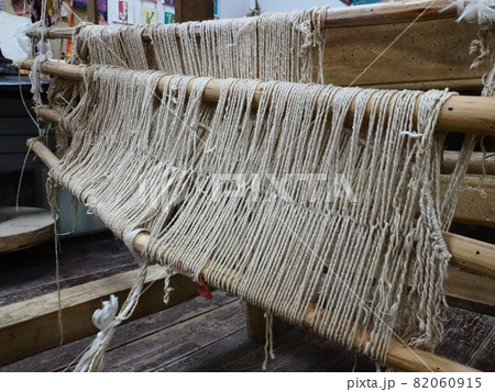 Loom and threads. Antique equipment for the production of carpets, clothing and woven household items. Threads and yarns are pulled over bushings and slats. Trsic, Loznica, Serbia. Ethno tourism Loom and threads. Antique equipment for the production of carpets, clothing and woven household items. Threads and yarns are pulled over bushings and slats. Trsic, Loznica, Serbia. Ethno tourism 82060915