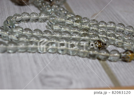Beautiful glass shiny prayer beads or rosary with copy space for text Beautiful glass shiny prayer beads or rosary with copy space for text 82063120
