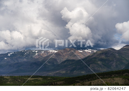 Inspirational mountain views. Thick gray clouds over the peaks. Inspirational mountain views. Thick gray clouds over the peaks. 82064247