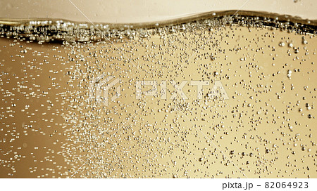 Close-up of champagne bubbles background with foam. Close-up of champagne bubbles background with foam. 82064923