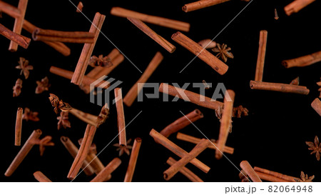 Cinnamon barks flying in the air. 82064948