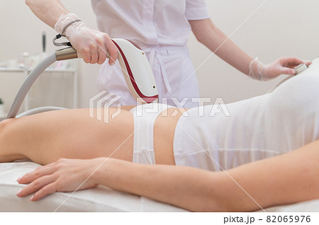 A woman in a professional beauty salon removes unwanted vegetation in the bikini area using laser hair removal A woman in a professional beauty salon removes unwanted vegetation in the bikini area using laser hair removal 82065976