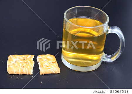 Transparent glass of green tea and pieces of cookies, healthy and balanced nutrition, diet Transparent glass of green tea and pieces of cookies, healthy and balanced nutrition, diet 82067513