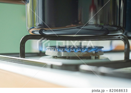 Peparing food on gas at home. Gas burner for a large pan. 82068633