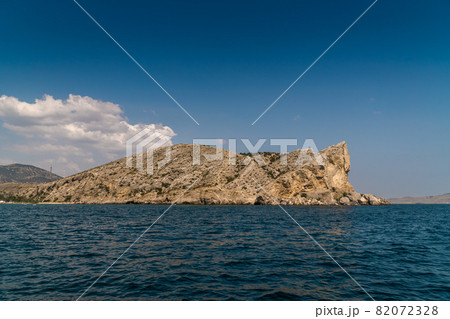 The Republic of Crimea. July 21, 2021. View of Mount Alchak, located near the city of Sudak, in sunny weather from the Black Sea. The Republic of Crimea. July 21, 2021. View of Mount Alchak, located near the city of Sudak, in sunny weather from the Black Sea. 82072328
