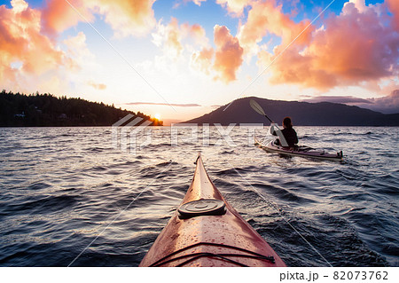 Adventurous Woman on Sea Kayak paddling in the Pacific Ocean. Adventurous Woman on Sea Kayak paddling in the Pacific Ocean. 82073762