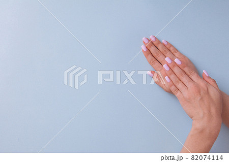 Beautiful woman pink manicure on creative blue background Beautiful woman pink manicure on creative blue background 82074114