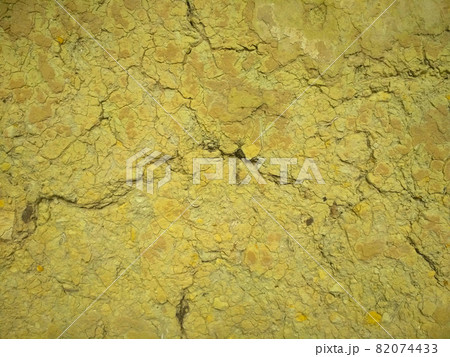 Texture of yellow cracked clay rock. Clay walls with cracks. Texture of yellow cracked clay rock. Clay walls with cracks. 82074433