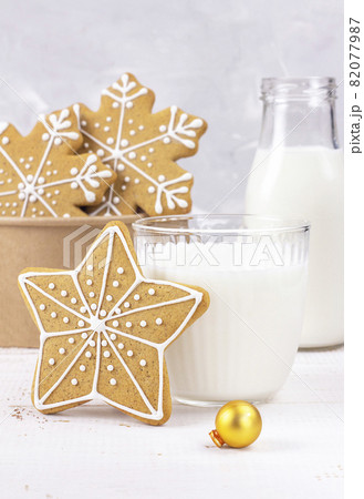 Delicious fresh milk on a white wooden background. Bottle of milk. Gingerbread Christmas. Delicious fresh milk on a white wooden background. Bottle of milk. Gingerbread Christmas. 82077987