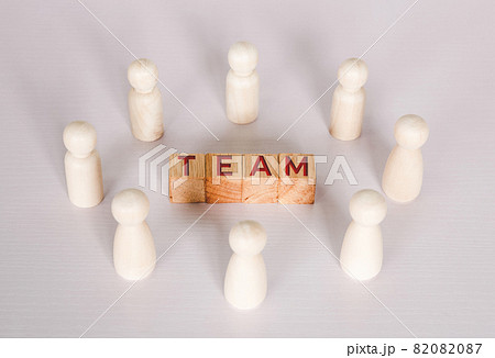 Word team on wooden block, relationship of collaboration and leadership for success. 82082087