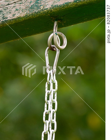 Knotted sports rope hanging from crossbar of horizontal bar Knotted sports rope hanging from crossbar of horizontal bar 82083737
