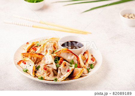 Fried dumplings served with green onions. Fried dumplings served with green onions. 82089189