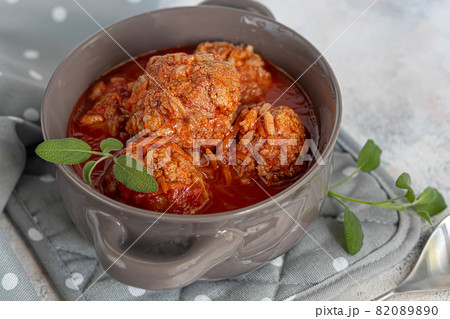 Meat balls on a light background with sage and parsley leaves. Homemade lunch. Meat balls on a light background with sage and parsley leaves. Homemade lunch. 82089890