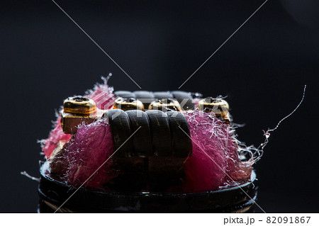 Vape close-up with wet cotton wool on black background 82091867