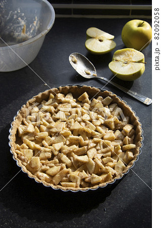 Cooking baking tart, with apple filling. Healthy wholemeal ,rustic traditional fruit tart. 82092058