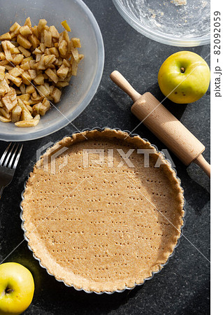 Raw shortbread dough for baking tart, apple pie and ingredients for home baking. 82092059