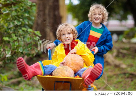 Kids on pumpkin patch. Child autumn outdoor fun. Kids on pumpkin patch. Child autumn outdoor fun. 82094500