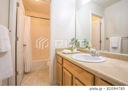 Modern bathroom interior with white wall and view of bathtub toilet and vanity 82094780