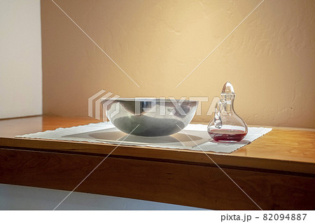 Red wine and bowl of wafers for Communion 82094887