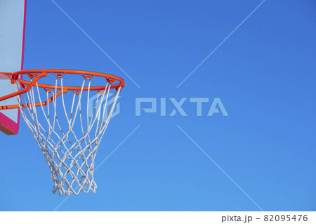 Close up on a basketball net against blue sky near sunset Close up on a basketball net against blue sky near sunset 82095476