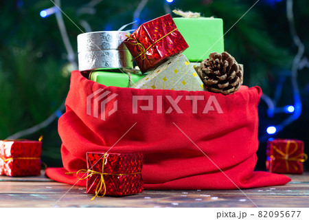 santa claus bag with gifts on christmas pine background 82095677