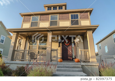 Small urban house decorated for Halloween on a sunny day 82097375